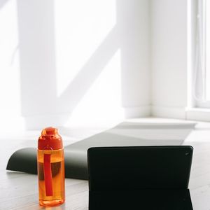 Clean minimal workout space with a mat and bottle